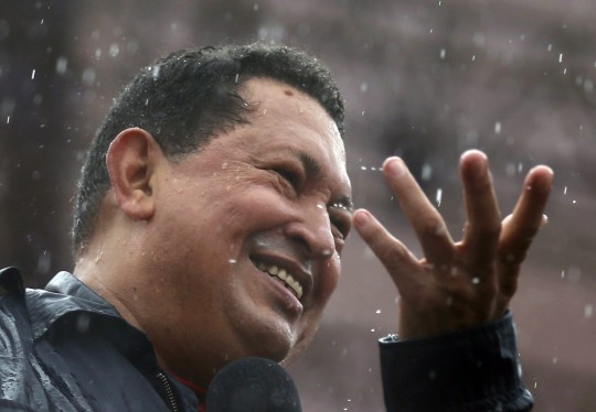 Venezuela's President and presidential candidate Hugo Chavez speaks in the rain during his closing campaign rally in Caracas